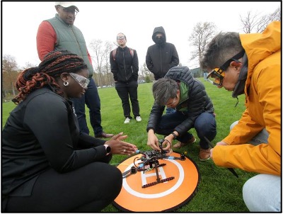 Students around a drone